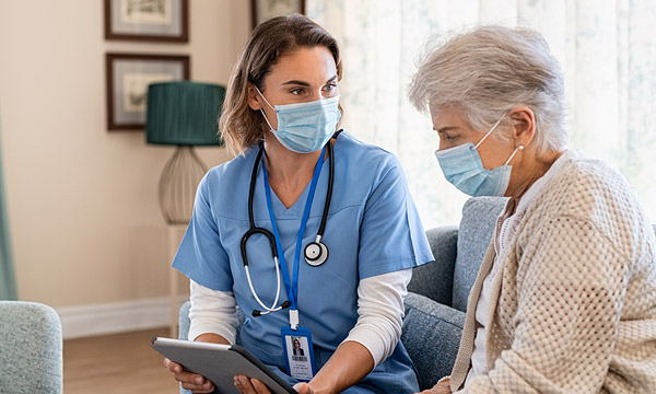 Healthcare professional assisting elderly patient